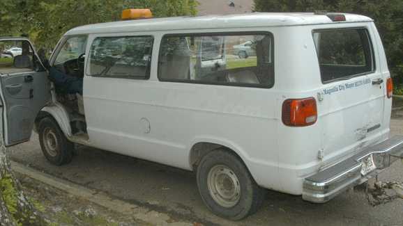 A Magnolia employee tasked with supervising inmates on work release allegedly sleeps inside a city van with his feet resting on the driver’s side door in this Aug. 15, 2013, photo courtesy of the Enterprise-Journal.