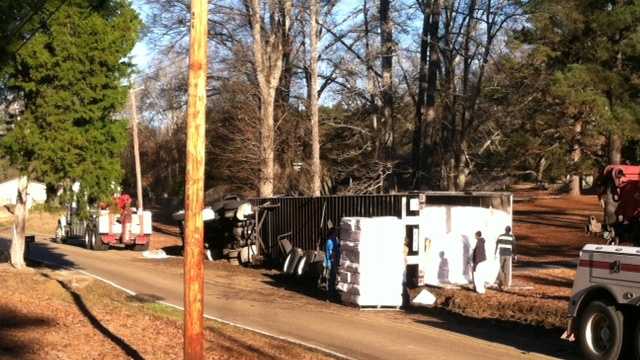An overturned 18-wheeler shuts down traffic on Main Street in Florence.