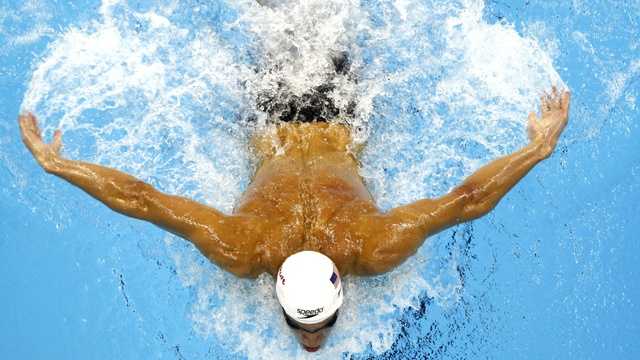 Coach at Phelps' swim club resigns