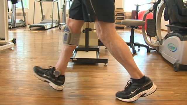 Dave Moriconi demonstrates how a device worn on his leg helps him walk after a paralyzing injury.