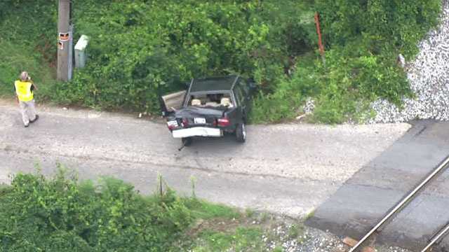 In photos: CSX train collides with car, injures 1 in Rosedale