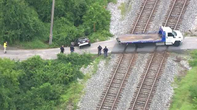 In photos: CSX train collides with car, injures 1 in Rosedale