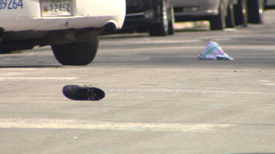A shoe is left in the street at the scene where a 16-year-old boy was shot Sunday.