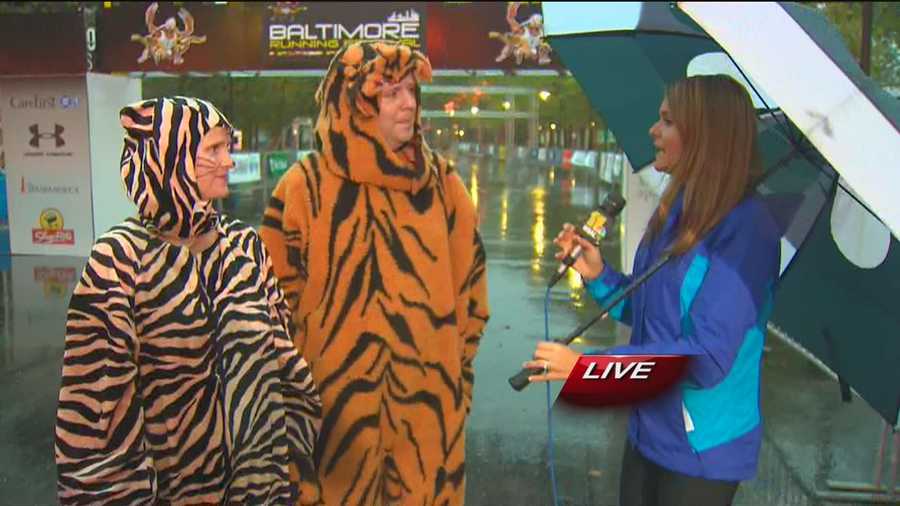 Ava Marie chats with two fur-clad Baltimore Running Festival groupies, one of which is known as the 'Eye of the Tiger Guy,' about their entertaining cheering routine put on at Mile 23 of the race at 30th Street and Guilford Avenue.