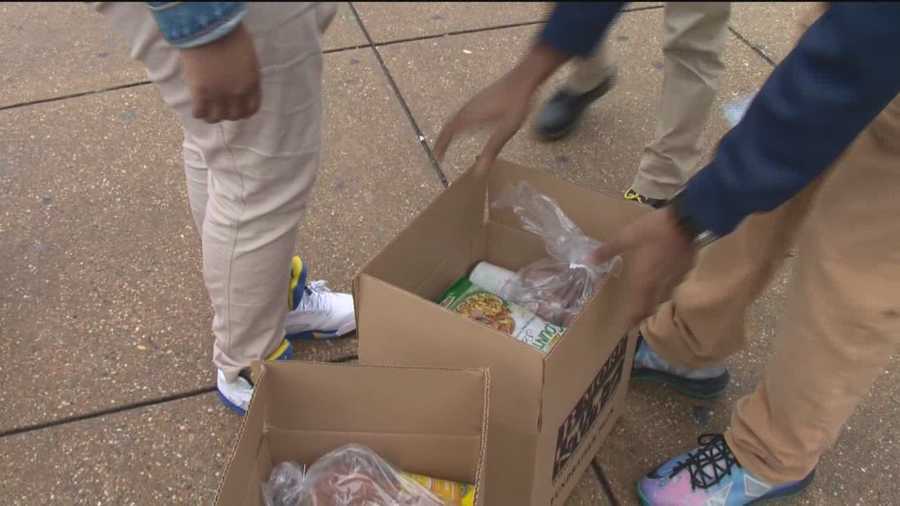 Just outside Baltimore Polytechnic High School, students traded in their book bags for boxes filled with ingredients for a Thanksgiving meal.