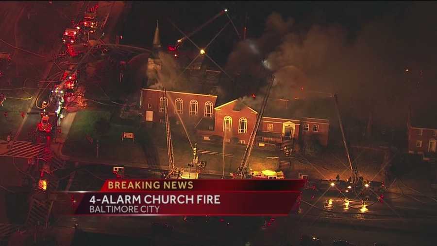 A four-alarm fire severely damages a church and school in Baltimore early Friday morning.