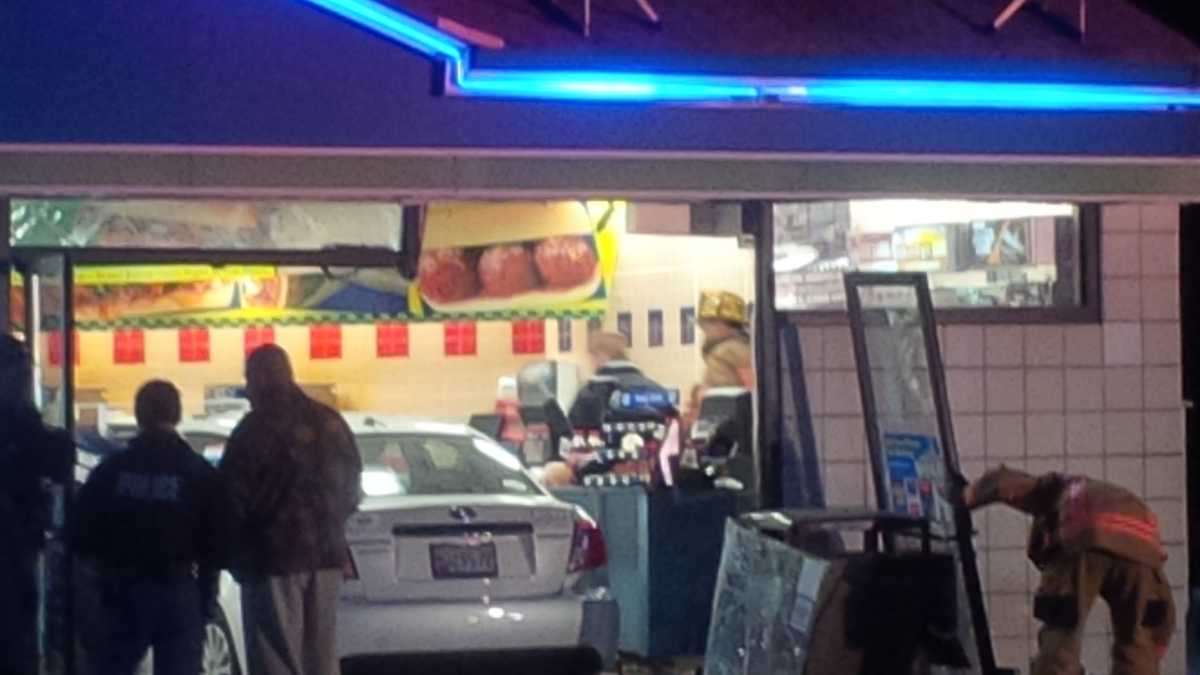 Woman injured after car drives through store