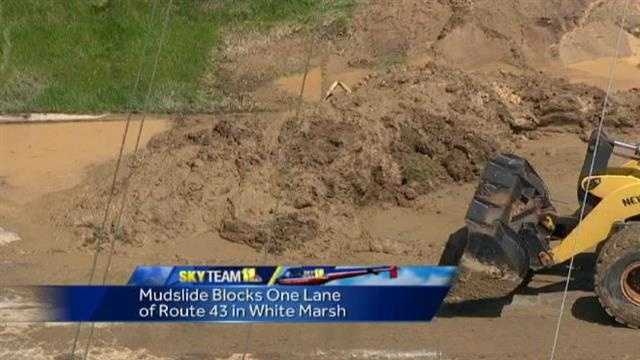 Crews could be seen at noon Thursday clearing out massive amounts of mud that streamed down a hill onto Route 43.