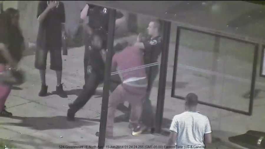 The Baltimore City police officer caught punching a man on surveillance video is placed on paid administrative leave.