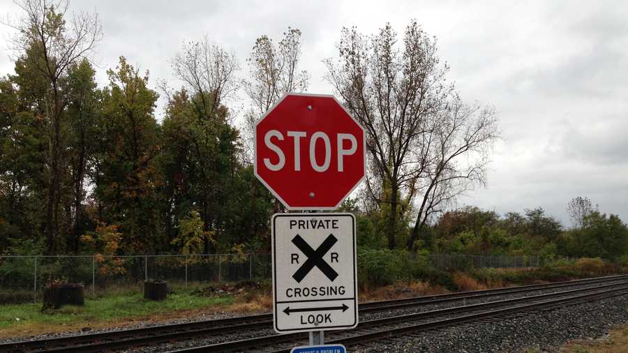 A new stop sign is placed on the access road at the railroad tracks.