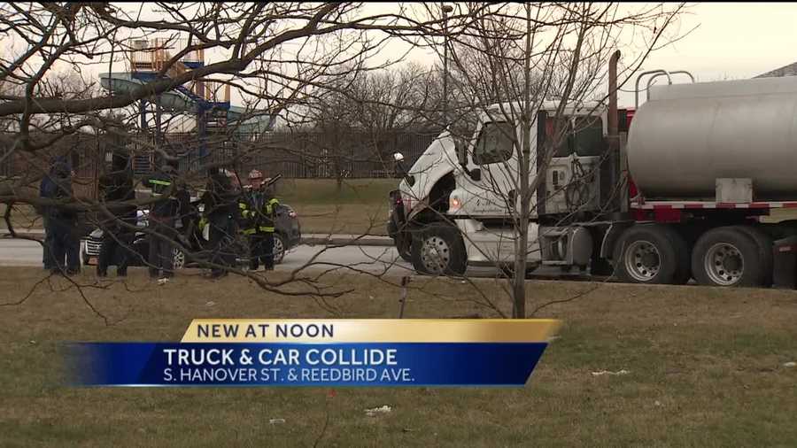 Three people were trapped Wednesday after a car collided with a tanker truck in south Baltimore.