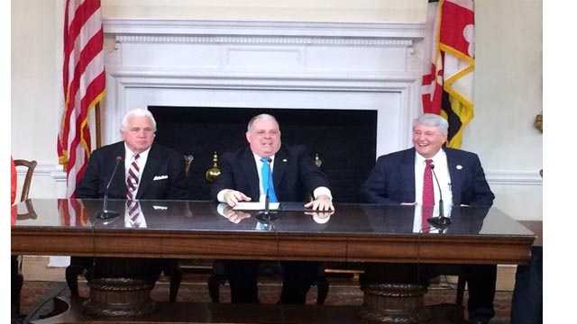 Gov. Larry Hogan is joined by Senate President Mike Miller, left, and House Speaker Michael Busch as he signs 100 bills into law from the 2016 General Assembly session.