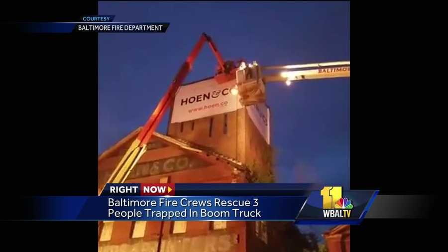 Firefighters rescued three workers trapped five stories up in the air in the bucket of a mobile boom truck Thursday night. Crews were called to the 2100 block of E. Chase Street at 8:30 p.m. on the report of a rescue alarm. When units arrived, they found the workers stuck, about five stories high. The preliminary investigation revealed that the workers were hanging a sign on the building when the machine lost power, causing them to be trapped.