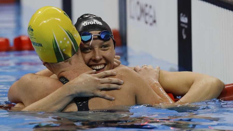 Lakeisha Patterson from Australia, front left, is embraced by Jessica Long from the United States, after Patterson won the women's 400-meter freestyle S8 final swimming event at the Paralympic Games in Rio de Janeiro, Brazil.