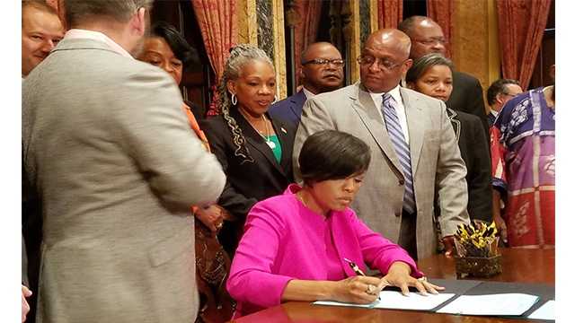 Mayor Stephanie Rawlings-Blake officially signed legislation that will pave the way for the city to commit $660 million in bonds toward the proposed development of Port Covington by Under Armour CEO Kevin Plank.