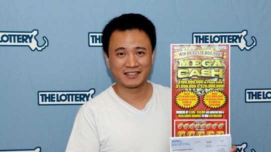 Yu Zhou with his winning Mega Cash scratch ticket.