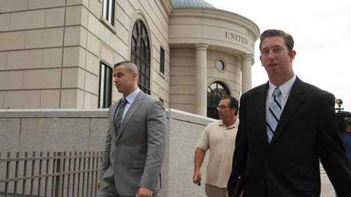 Pleasantville, N.Y., police officer Aaron Hess, left, leaves the courthouse with his attorney.