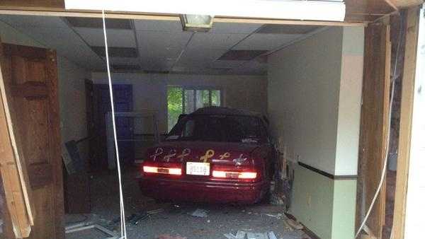 A two car crash lands an elderly driver and her car inside a Charlton home.
