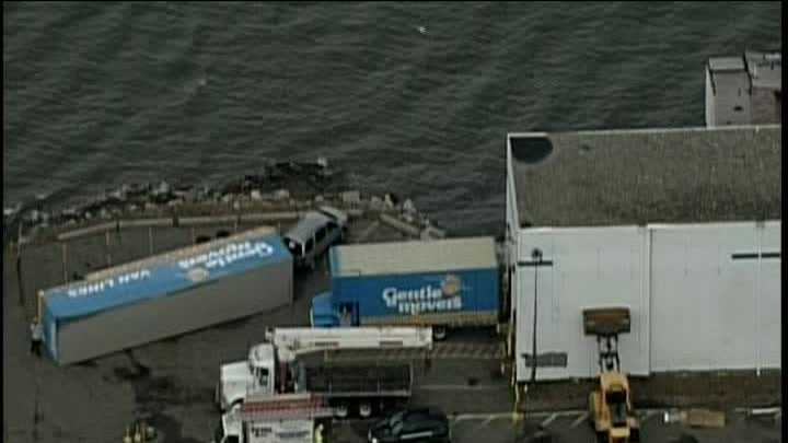 Wind flips moving truck over, causes partial building collapse