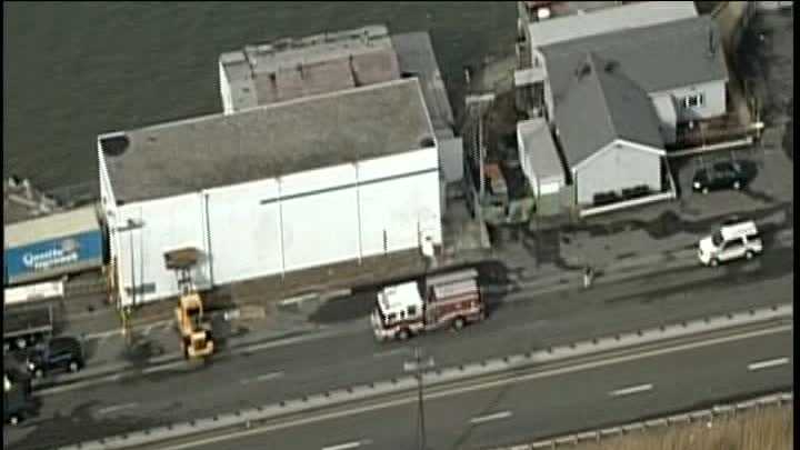 Wind flips moving truck over, causes partial building collapse