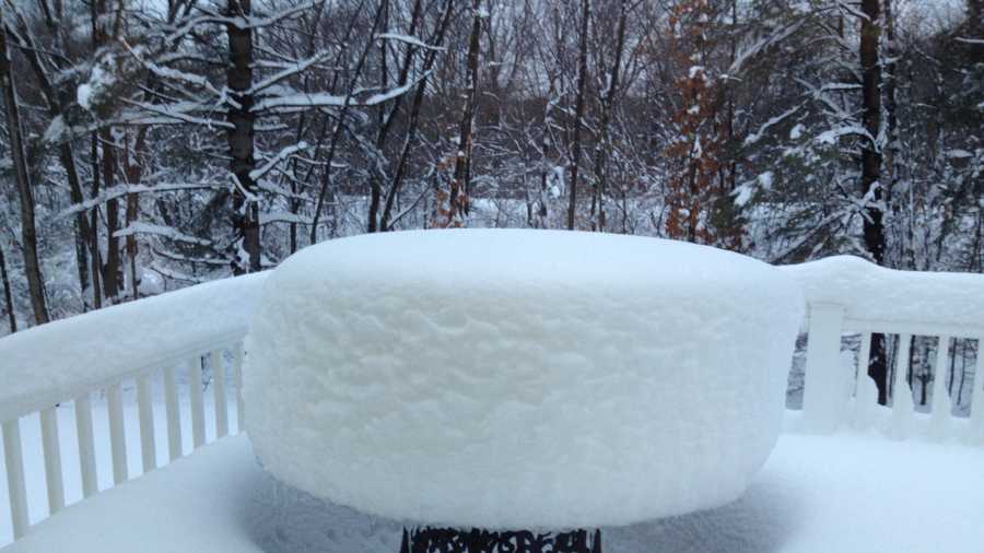 Snow accumulates on a backyard table in Walpole.