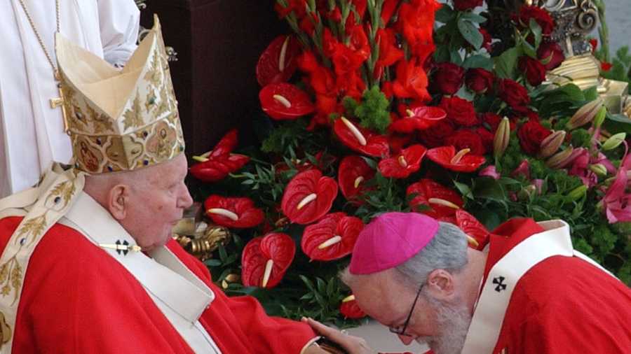 June 29, 2004: O'Malley pays homage to Pope John Paul II after receiving the pallium during an ancient rite. The pallium is a band of white wool decorated with black crosses that symbolizes the bond with the Vatican. 