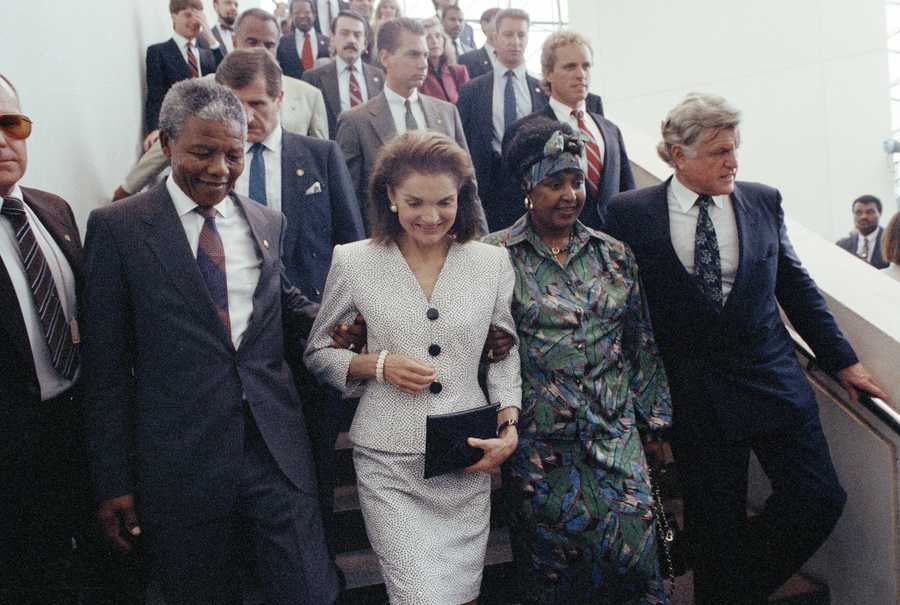 Jacqueline Kennedy Onassis escorts Nelson Mandela during Mandela's visit to the John F. Kennedy Library on June 23, 1990 in Boston.