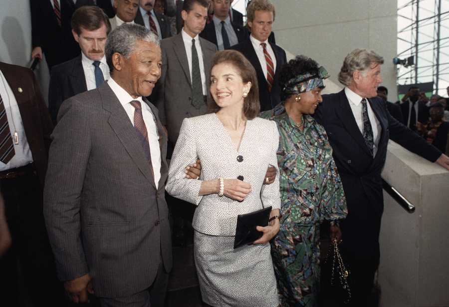 Jacqueline Kennedy Onassis casts a smiling glance at Nelson Mandela, deputy president of the African National Congress, during Mandela's visit to the John F. Kennedy Library on June 23, 1990 in Boston. The Kennedy family has been a longtime opponent of South Africa's policy of apartheid.