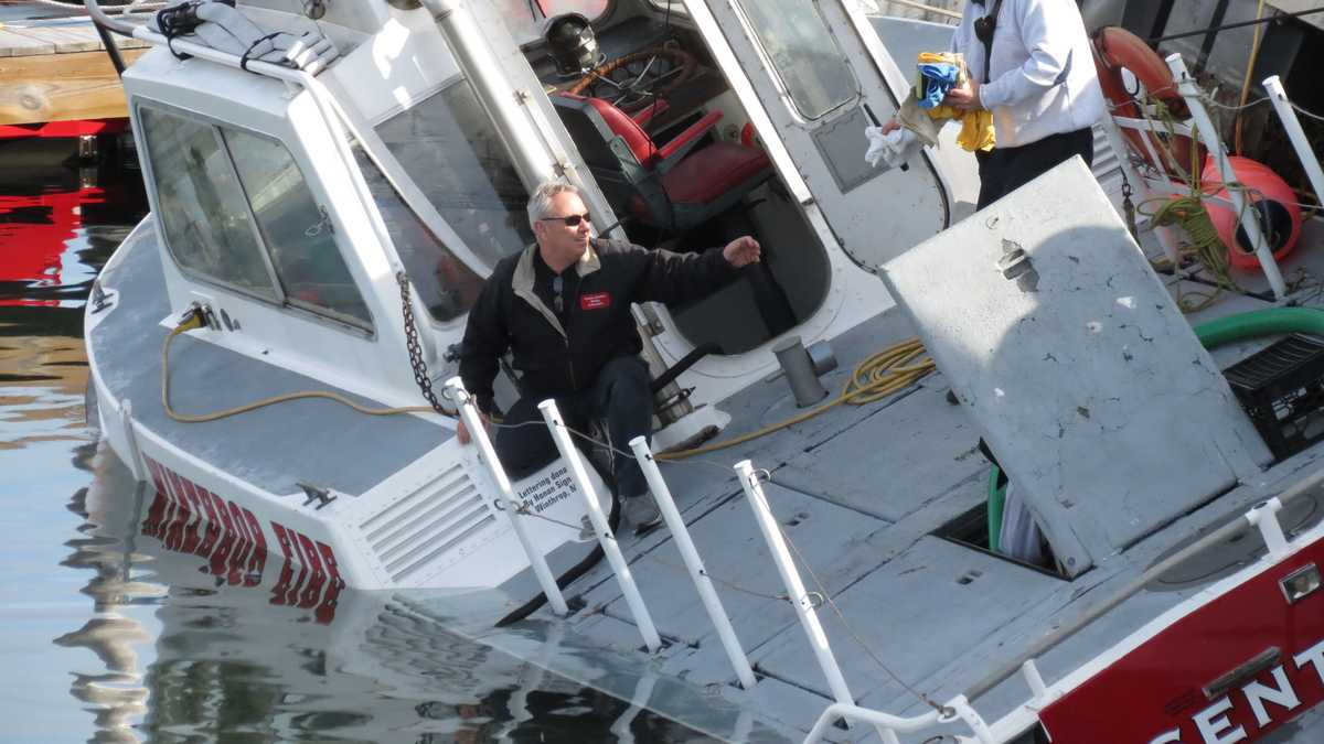 Images Winthrop fire boat takes on water, tips under pier
