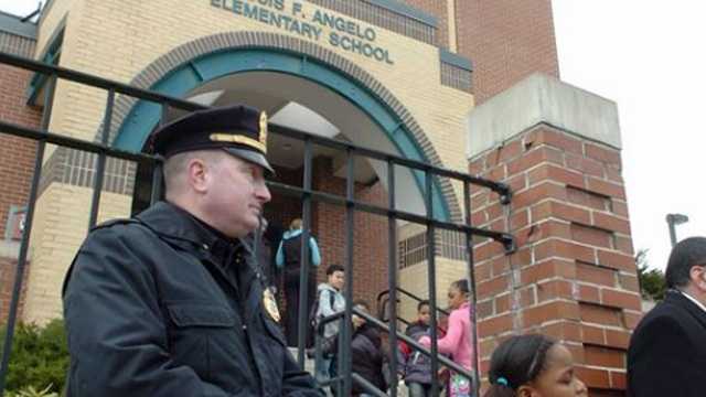 Brockton police Lt. Donald Mills stands guard at the front entrance at the Angelo School in March 2011. A BB gun was fired in the school playground and on a bus by an 11-year-old student