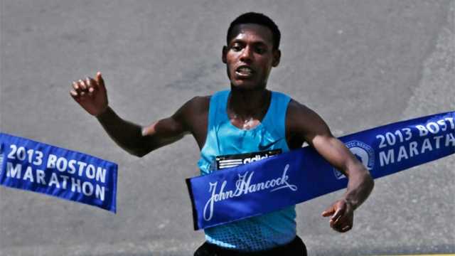 Lelisa Desisa, of Ethiopia, breaks the finish line tape to win the 2013 running of the Boston Marathon in Boston, April 15, 2013.