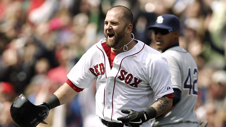 Boston Red Sox's Mike Napoli celebrates after his game-winning double as Tampa Bay Rays' Yunel Escobar watches during the ninth inning of a baseball game at Fenway Park in Boston on Monday, April 15, 2013. Boston won 3-2.