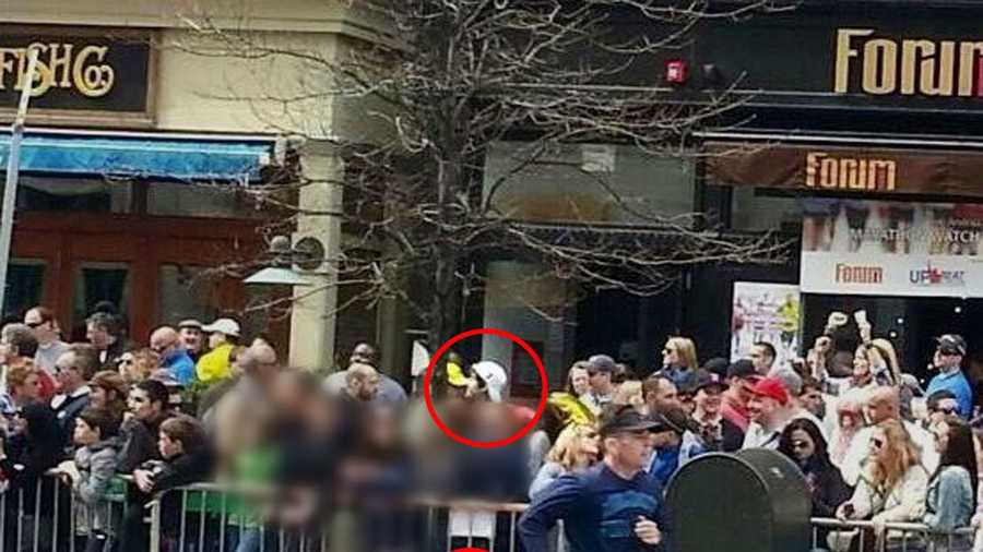 This photo taken before the bombings shows suspect Dzhokhan Tsarnaev in the background with what may be the bomb in a backpack in the lower part of the frame near the railing.