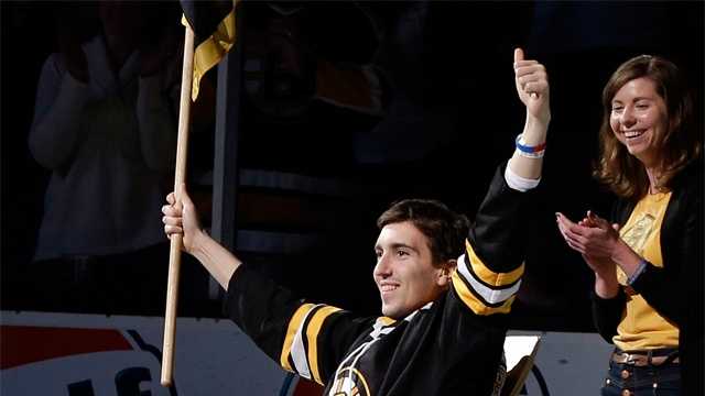 Boston Marathon bombing victim Jeff Bauman reacts as he is honored as the official flag-bearer before Game 2 of a first-round NHL hockey playoff series between the Boston Bruins and the Toronto Maple Leafs in Boston, May 4, 2013. 