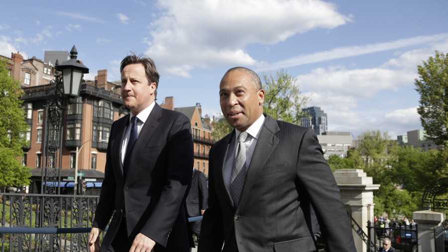 British Prime Minister David Cameron, left, walks with Massachusetts Gov. Deval Patrick into the Massachusetts Statehouse in Boston, Monday, May 13, 2013. Cameron met with Patrick to offer his condolences and discuss lessons that can be learned from the Boston Marathon attacks.