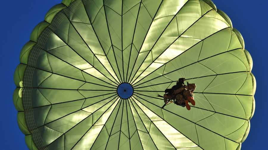 FILE - A paratrooper participates in a personnel drop, an exercise that uses several Air Force aircraft to strategically airdrop troops and cargo.
