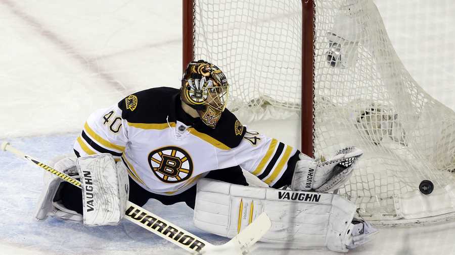 Boston Bruins goalie Tuukka Rask deflects a shot on goal during the first period in Game 4 of the Eastern Conference semifinals in the NHL hockey Stanley Cup playoffs against the New York Rangers.