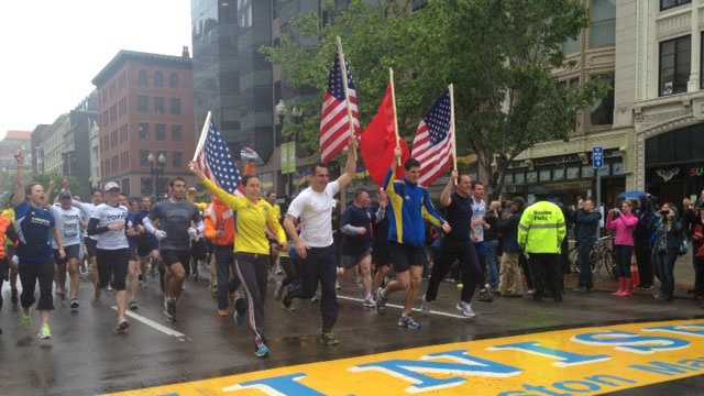 Runners cross the Boston Marathon finish line in the OneRun on Saturday, May 25, 2013.