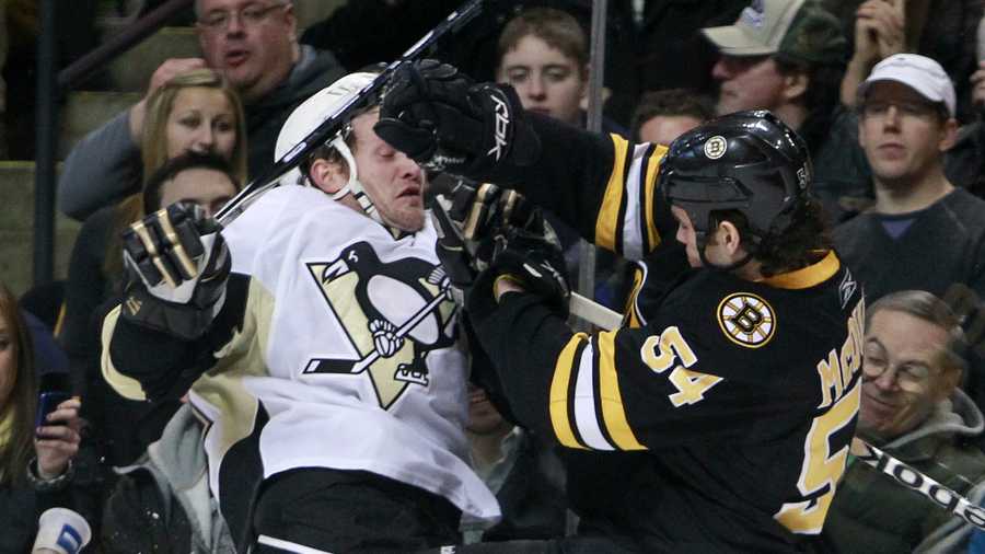 Boston Bruins' Adam McQuaid (54) checks Pittsburgh Penguins' Matt Cooke in the first period of an NHL hockey game, Saturday, Jan. 15, 2011, in Boston. 