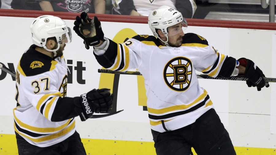 Boston Bruins' Brad Marchand, right, celebrates his goal with teammate Patrice Bergeron (37) in the first period of Game 2 of the NHL hockey Stanley Cup Eastern Conference finals against the Pittsburgh Penguins in Pittsburgh Monday, June 3, 2013.