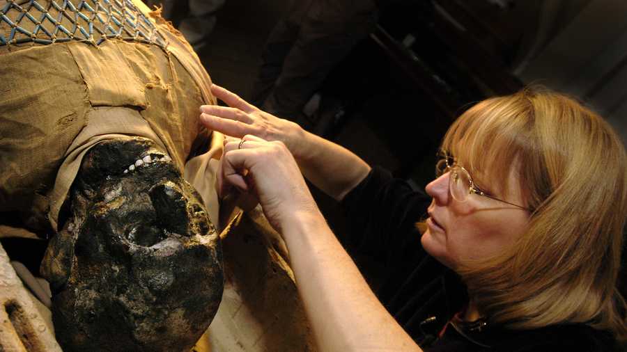 Egyptologist Mimi Leveque begins to remove the protective wrappings around a 2,500 year-old mummy at Massachusetts General Hospital in Boston. 