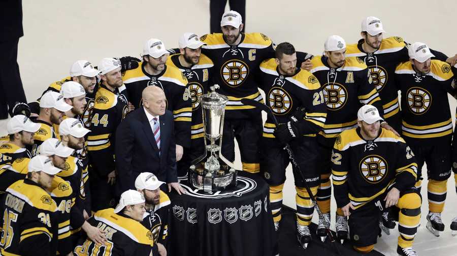 The Boston Bruins pose with the trophy after beating the Pittsburgh Penguins 1-0 in Game 4 of the Eastern Conference finals of the NHL hockey Stanley Cup playoffs in Boston, Friday, June 7, 2013. The Bruins advanced to the Stanley Cup finals. 