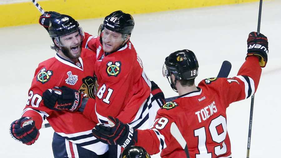 Chicago Blackhawks left wing Brandon Saad (20) celebrates with right wing Marian Hossa (81) and center Jonathan Toews (19) after scoring a goal during the second period of Game 1 in their NHL Stanley Cup Final hockey series against the Boston Bruins, Wednesday, June 12, 2013, in Chicago.
