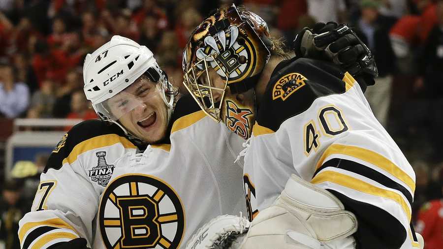 Boston Bruins defenseman Torey Krug (47) celebrates with goalie Tuukka Rask (40) after the Bruins scored a goal against the Chicago Blackhawks in sudden death overtime during Game 2 of the NHL hockey Stanley Cup Finals, Saturday, June 15, 2013, in Chicago. The Bruins won 2-1. 