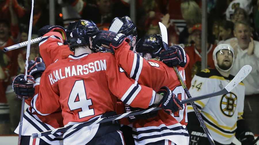 The Chicago Blackhawks celebrate a second period goal against the Boston Bruins during Game 5 of the NHL hockey Stanley Cup Finals, Saturday, June 22, 2013, in Chicago.
