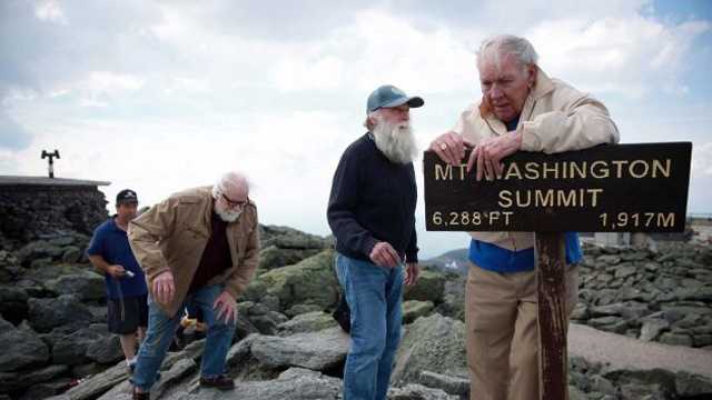  In this June 1, 2013 photo, Guy Gosselin, left, makes his way to the summit of Mount Washington to reunite with Gerry Wright, center, and Harold Addison, right, in Gorham, N.H. Gosselin, who was working at the observatory atop the mountain, helped Wright and Addison, who needed food and shelter from the cold and high winds during their summit attempt 50 years ago. 