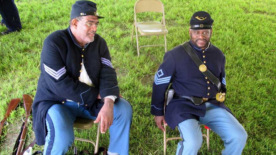 Walter Sanderson of Upper Marlboro, Md., left, and Louis Carter of Richmond, Va., re-enactors portraying members of the 54th Massachusetts Volunteer Infantry, sit in an encampment at Fort Moultrie on Sullivans Island, S.C., on Thursday, July 18, 2013. The re-enactors gathered to commemorate the 150th anniversary of the famed Civil War attack by the 54th Massachusetts Volunteer Infantry in a fight commemorated in the film "Glory."
