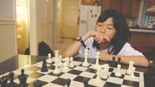 Carissa Yip, 9, considers her next move on the chessboard.
