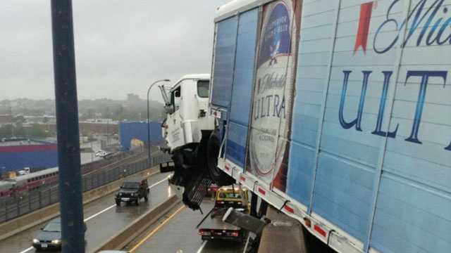 The Boston Fire Department said the truck driver and his passenger are both out of the vehicle.