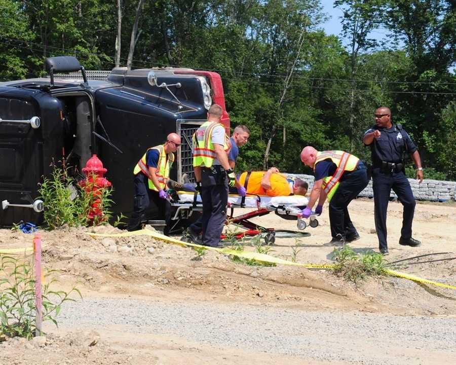 Photos Driver injured after dump truck tips over